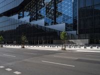 a parking lot sitting under a glass building on a street corner next to another building