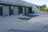 a view of an outside area of an office building with large windows and a circular driveway