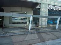 a street side building with an empty sidewalk outside of it and cars parked beside the building