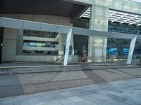 a street side building with an empty sidewalk outside of it and cars parked beside the building