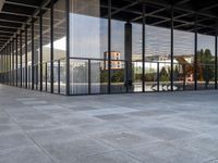 the large floor of a building with many windows in it's sides and an empty sidewalk on the side