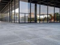 the large floor of a building with many windows in it's sides and an empty sidewalk on the side