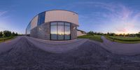 the spherical photo shows the building that looks like a house and its reflection on the glass