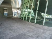 the hallway and walkways of a building with a curved glass wall in front of it