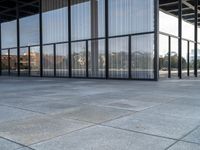 glass walls and windows in an empty room with a skateboarder on a platform