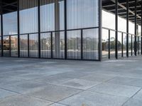 glass walls and windows in an empty room with a skateboarder on a platform