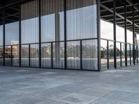 glass walls and windows in an empty room with a skateboarder on a platform