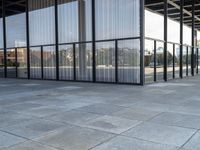 glass walls and windows in an empty room with a skateboarder on a platform