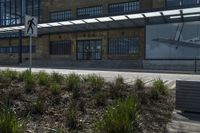 there are two airplanes displayed on the building wall near the crosswalk and sidewalk in front of the building