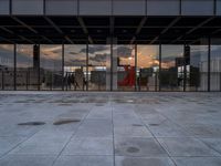 the reflection of the sun is in the glass walls of an empty building with no people