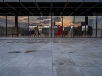 the reflection of the sun is in the glass walls of an empty building with no people