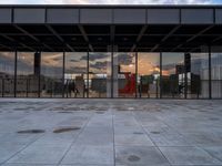 the reflection of the sun is in the glass walls of an empty building with no people