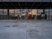 the reflection of the sun is in the glass walls of an empty building with no people