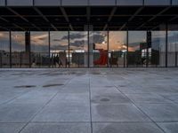 the reflection of the sun is in the glass walls of an empty building with no people