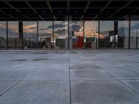 the reflection of the sun is in the glass walls of an empty building with no people