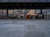 the reflection of the sun is in the glass walls of an empty building with no people