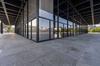 the large building is empty, with the reflection of another building in the window glass