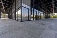 the large building is empty, with the reflection of another building in the window glass