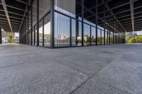 the large building is empty, with the reflection of another building in the window glass