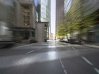 an empty city street filled with lots of tall buildings and plants growing on the sides