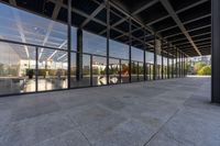 a view from outside of a large building with lots of glass walls and flooring