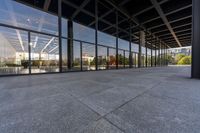 a view from outside of a large building with lots of glass walls and flooring