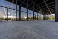 a view from outside of a large building with lots of glass walls and flooring