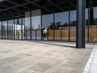 a parking lot has windows with wooden panels on them and concrete blocks and pavers