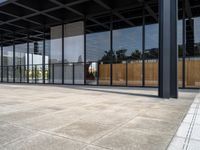 a parking lot has windows with wooden panels on them and concrete blocks and pavers