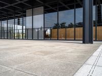 a parking lot has windows with wooden panels on them and concrete blocks and pavers