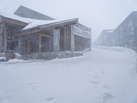 people walking through the snow in front of lodge on the slopes of a mountain resort