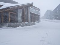 people walking through the snow in front of lodge on the slopes of a mountain resort