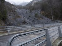 Gloomy Alps Landscape: Metal Bridge Across the Mountains