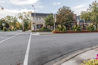 the intersection of a residential and town street in fall with a red fire hydrant