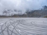 a wide shot of a foggy mountain on an empty runway, with circular markings