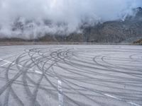 a wide shot of a foggy mountain on an empty runway, with circular markings