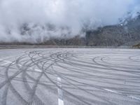 a wide shot of a foggy mountain on an empty runway, with circular markings