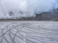 a wide shot of a foggy mountain on an empty runway, with circular markings