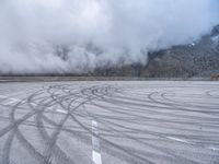 a wide shot of a foggy mountain on an empty runway, with circular markings