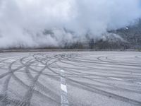 a wide shot of a foggy mountain on an empty runway, with circular markings