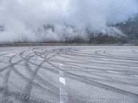 a wide shot of a foggy mountain on an empty runway, with circular markings