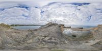 the sky is filled with clouds and rocks that resemble large hollows and other features of stone