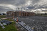 the construction site is under construction as clouds gather over the house on the street side