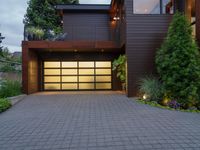 a garage with a nice house front and windows and steps to the backyard area outside