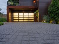 a garage with a nice house front and windows and steps to the backyard area outside