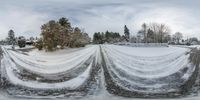 a water main running down a street next to snow covered ground and trees in the background