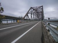 the bridge is constructed from concrete and supports the roadway below it on a cloudy day