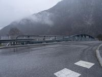 A Gloomy Day in the French Alps: Wet Road and Eerie Atmosphere