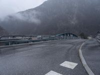 A Gloomy Day in the French Alps: Wet Road and Eerie Atmosphere