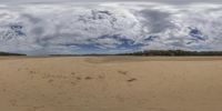 a cloudy day is seen through a fisheye lens photo of the beach at lake george